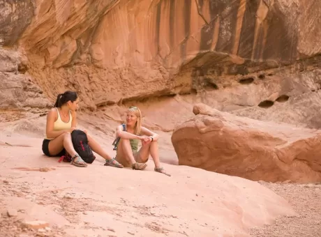 rock-climbers-relaxing-on-boulder.webp